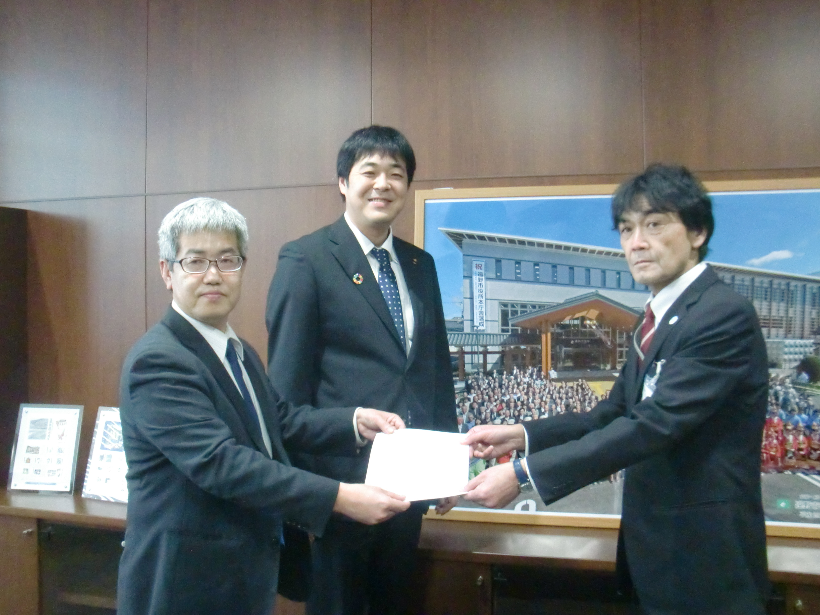 大和田議長（左）から飛内副市長（右）に要請。中央は小松市議。